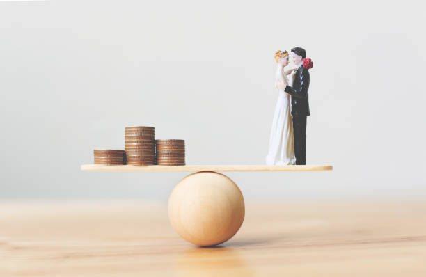 Figuras de novios en equilibrio sobre una balanza